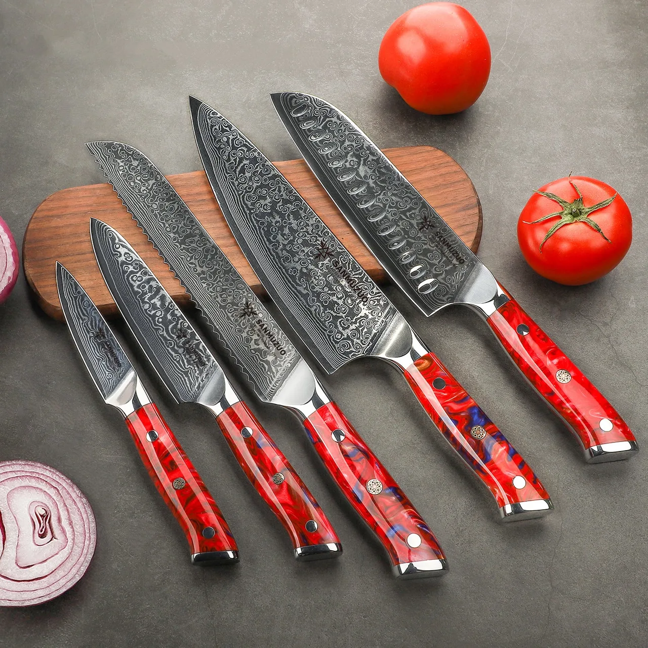 Coordinated red XUAN kitchen knife collection on a kitchen surface